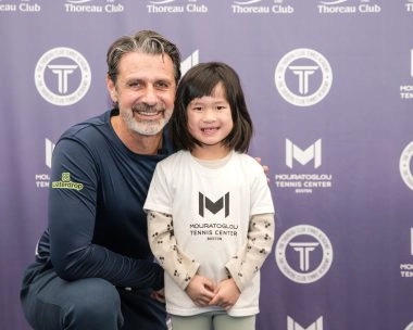 Patrick Mouratoglou smiling with a young player at Mouratoglou Tennis Center Boston