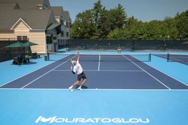 Tennis players training on court at Mouratoglou Tennis Center Boston in Massachusetts
