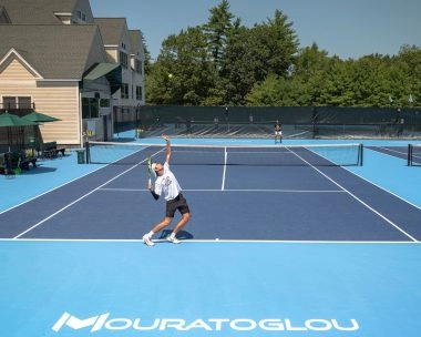 Tennis players training on court at Mouratoglou Tennis Center Boston in Massachusetts