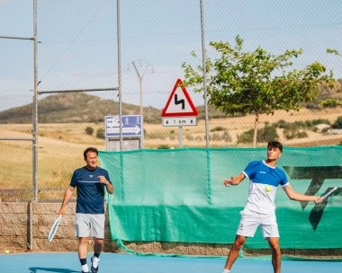 Tennis player in action on a blue hard court at Mouratoglou Tennis Center Calatrava