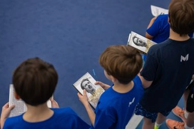 Young players holding Patrick Mouratoglou’s book at Mouratoglou Tennis Center Boston