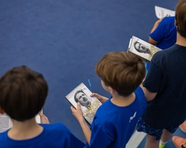 Young players holding Patrick Mouratoglou’s book at Mouratoglou Tennis Center Boston