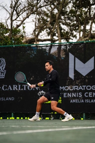 Tennis coach playing on the courts at Mouratoglou Tennis Center Amelia Island.