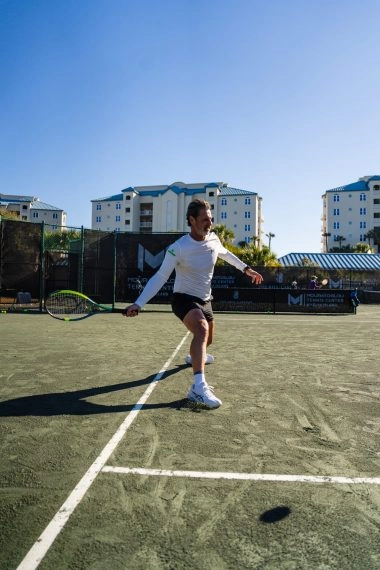 Patrick Mouratoglou playing on the tennis courts at Mouratoglou Tennis Center Amelia Island.