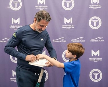 Patrick Mouratoglou signing his book for a young player at Mouratoglou Tennis Center Boston