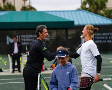 Patrick Mouratoglou giving a fist bump to a junior program player at Mouratoglou Tennis Center Amelia Island.