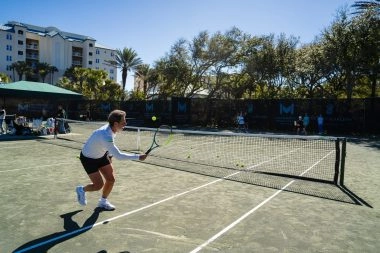 Patrick Mouratoglou playing tennis on the courts at Mouratoglou Tennis Center Amelia Island.