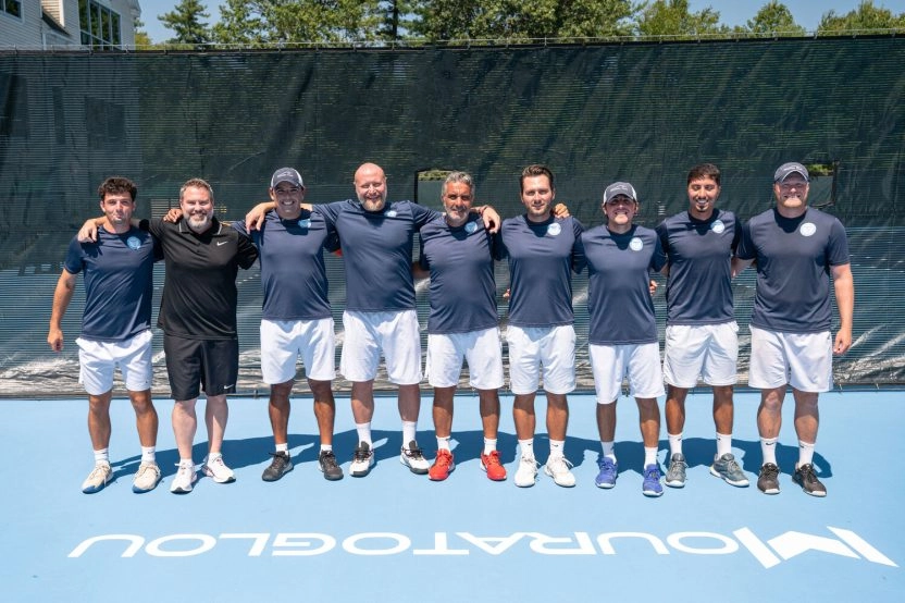 Team of professional tennis coaches on court in Massachusetts