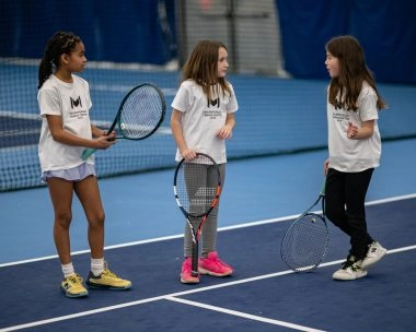 Children laughing on court at Mouratoglou Tennis Center Boston