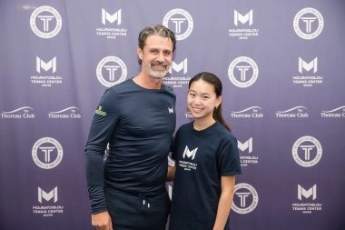 Patrick Mouratoglou smiling with a young player at Mouratoglou Tennis Center Boston