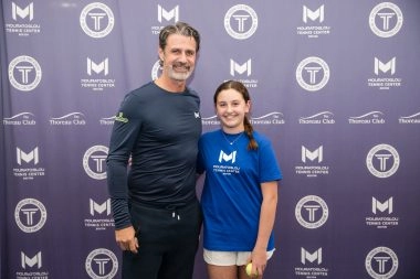 Patrick Mouratoglou posing with a young female player at Mouratoglou Tennis Center Boston, Massachusetts