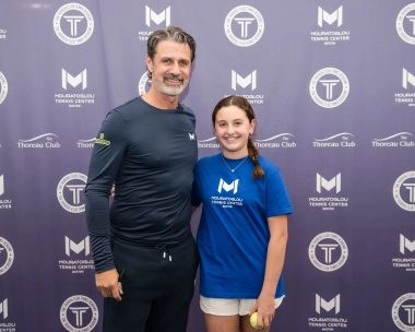 Patrick Mouratoglou posing with a young female player at Mouratoglou Tennis Center Boston, Massachusetts