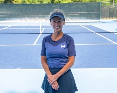 Tennis coach posing on court at Mouratoglou Tennis Center Boston