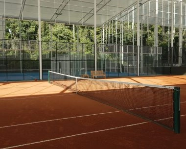 Clay tennis court at Mouratoglou Tennis Center Bali surrounded by lush tropical scenery