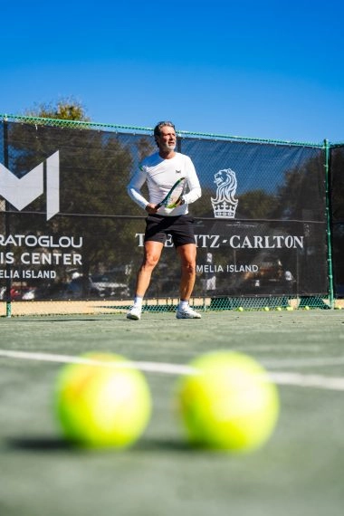 Patrick Mouratoglou playing tennis on court at Mouratoglou Tennis Center Amelia Island.