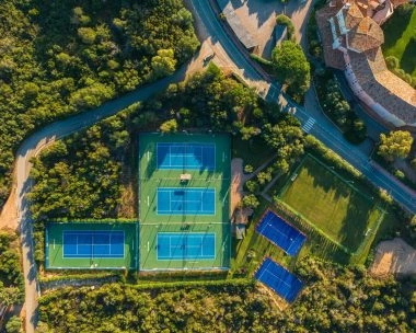 Aerial view of tennis courts, padel courts and football field at Mouratoglou Tennis Center Cala di Volpe in Costa Smeralda, Sardinia.