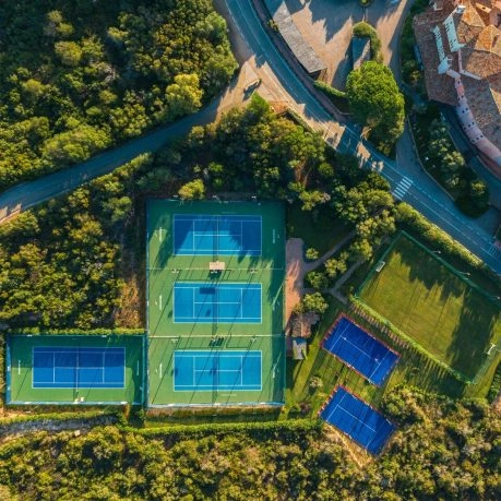 Aerial view of tennis courts, padel courts and football field at Mouratoglou Tennis Center Cala di Volpe in Costa Smeralda, Sardinia.