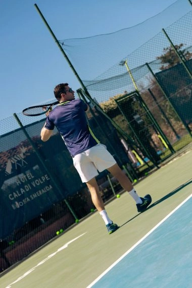 Tennis player hitting a forehand at Mouratoglou Tennis Center Cala di Volpe in Costa Smeralda, Sardinia.