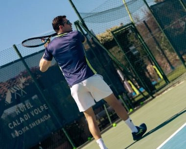 Tennis player hitting a forehand at Mouratoglou Tennis Center Cala di Volpe in Costa Smeralda, Sardinia.