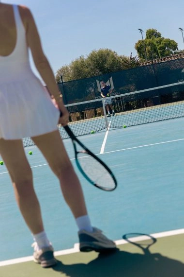Tennis players practicing on court at Mouratoglou Tennis Center Cala di Volpe in Costa Smeralda, Sardinia.