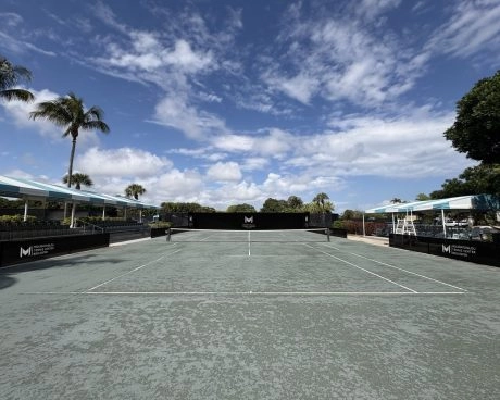 Outdoor tennis courts at Mouratoglou Tennis Center Boca Raton used for training sessions in a sunny Florida setting.