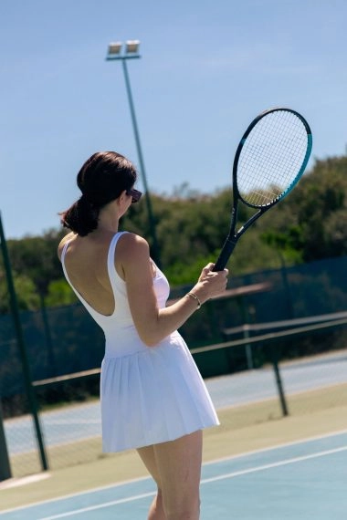 Female tennis player practicing on court at Mouratoglou Tennis Center Cala di Volpe in Costa Smeralda, Sardinia.
