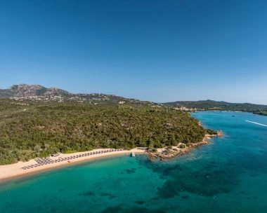 Private beach with turquoise water near Mouratoglou Tennis Center Cala di Volpe in Costa Smeralda, Sardinia.