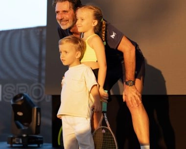 Patrick Mouratoglou posing with two children during an event at Mouratoglou Tennis Center Hudayriyat Island in Abu Dhabi.