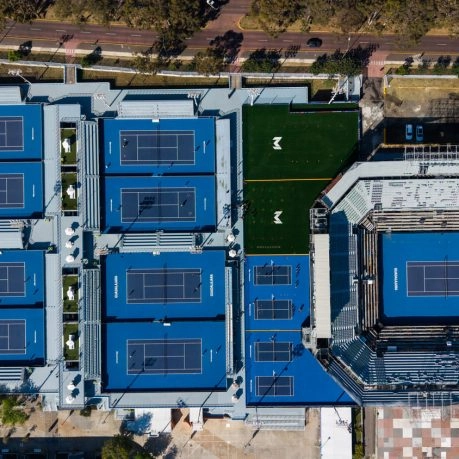 Aerial view of Mouratoglou Tennis Center Guadalajara with multiple tennis courts and a main stadium court.
