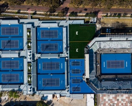 Aerial view of Mouratoglou Tennis Center Guadalajara with multiple tennis courts and a main stadium court.