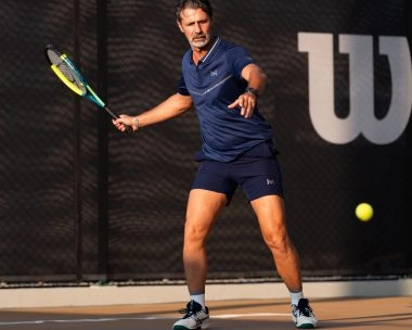 Patrick Mouratoglou hitting a forehand on a tennis court at Mouratoglou Tennis Center Hudayriyat Island in Abu Dhabi.