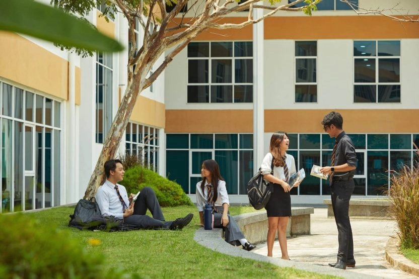 Students talking together on the campus of Epsom College in Malaysia at Mouratoglou Academy Malaysia.