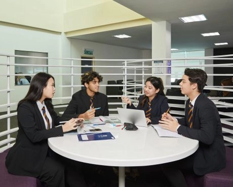 Students studying together around a table at Mouratoglou Academy Malaysia.