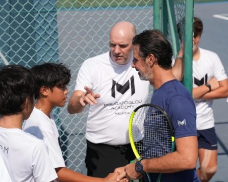 Patrick Mouratoglou talking with students on a tennis court at Mouratoglou Academy Malaysia on the campus of Epsom College in Malaysia.