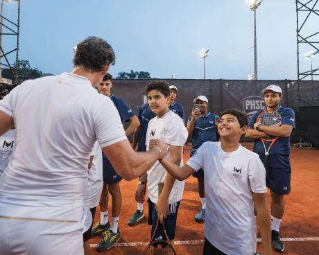 Patrick Mouratoglou greeting a young tennis player during a junior tennis event at Mouratoglou Tennis Center Palm Hills Cairo in Egypt.