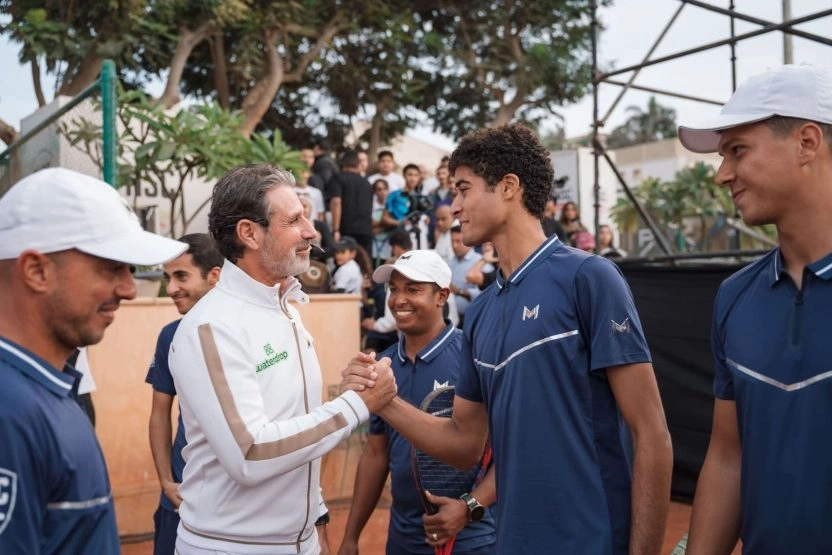 Patrick Mouratoglou congratulating a young player with a handshake at Mouratoglou Tennis Center Palm Hills, Egypt