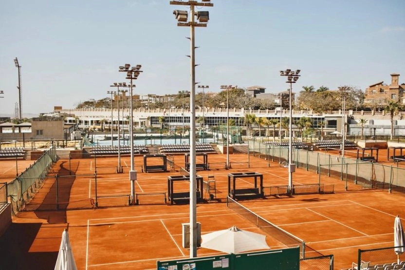 Panoramic view of multiple clay tennis courts at Mouratoglou Tennis Center Palm Hills Cairo in Egypt.