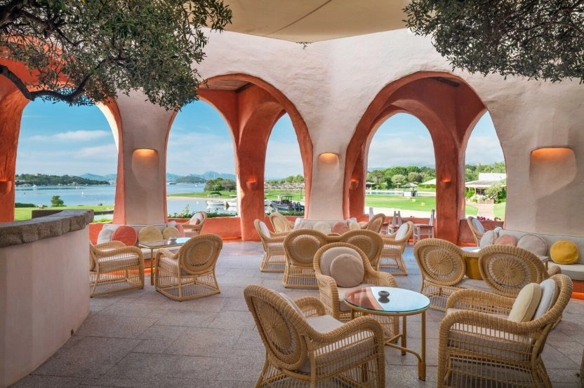 Elegant seating area at the Atrium Bar of Hotel Cala di Volpe featuring Mediterranean architecture and views over the Costa Smeralda landscape.