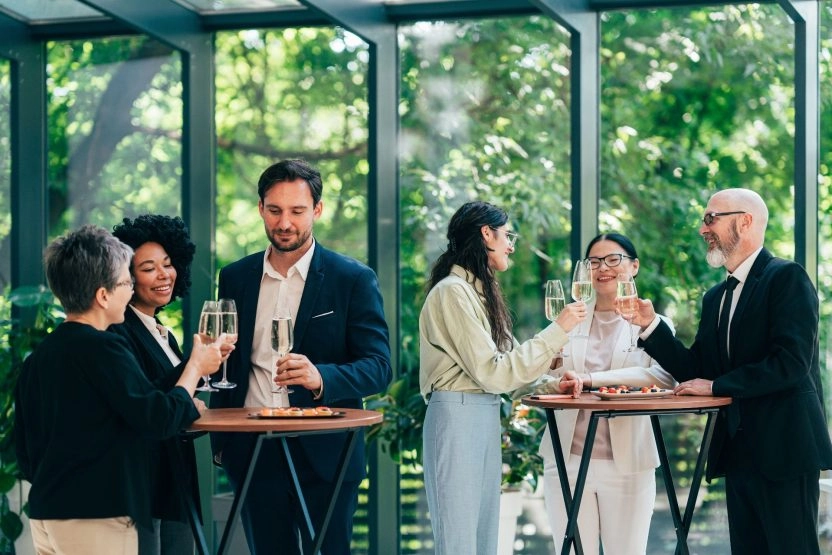 Professionals networking and socializing during a corporate event organized by Mouratoglou Tennis Center.