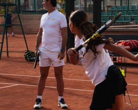 Patrick Mouratoglou watching a junior tennis player during a training session on a clay court at Mouratoglou Tennis Center Palm Hills Cairo in Egypt.