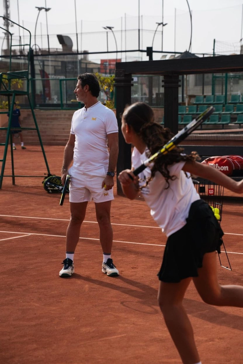 Patrick Mouratoglou watching a junior tennis player during a training session on a clay court at Mouratoglou Tennis Center Palm Hills Cairo in Egypt.