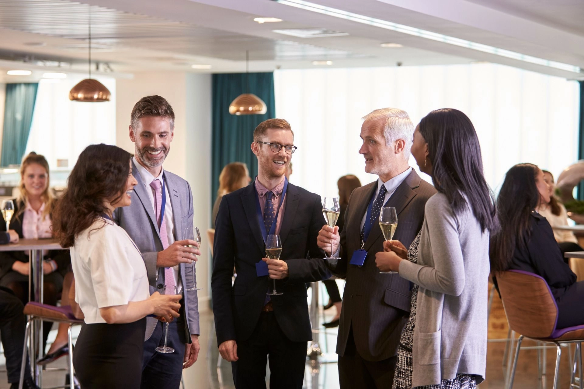 Professionals networking and socializing during a corporate event organized by Mouratoglou Tennis Center.