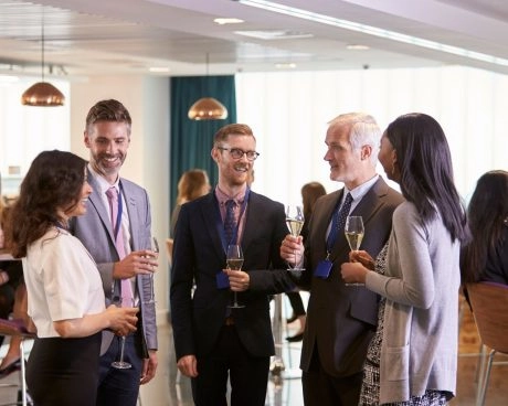 Professionals networking and socializing during a corporate event organized by Mouratoglou Tennis Center.