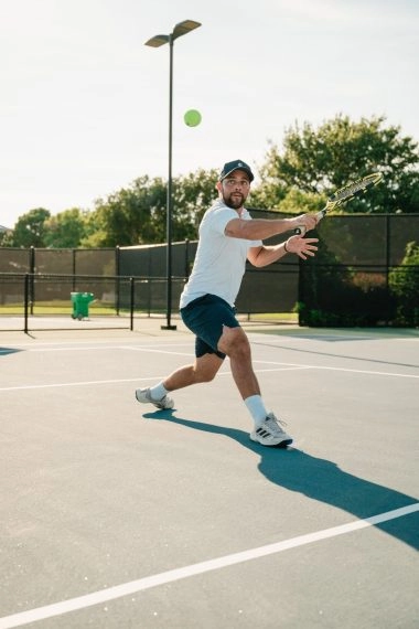 Tennis player hitting a forehand on an outdoor court at Mouratoglou Tennis Center Odessa Midland, located within La Estancia.