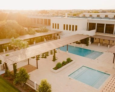 Aerial view of the outdoor swimming pool and country club facilities at Mouratoglou Tennis Center Odessa Midland, La Estancia.