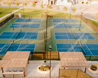 Aerial view of eight outdoor pickleball courts at Mouratoglou Tennis Center Odessa Midland, located within La Estancia country club.