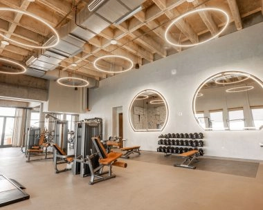 Modern fitness center with strength equipment and free weights at Mouratoglou Tennis Center Odessa Midland, La Estancia.