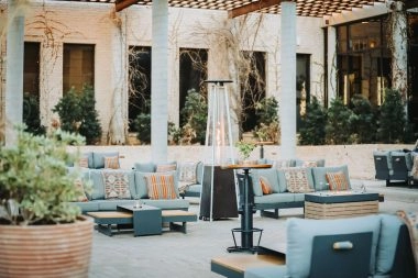 Outdoor lounge with sofas, fire tables and patio heaters at La Estancia, home of Mouratoglou Tennis Center Odessa Midland.