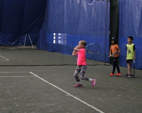Young tennis players practicing on an indoor court at Mouratoglou Tennis Center Westchester.